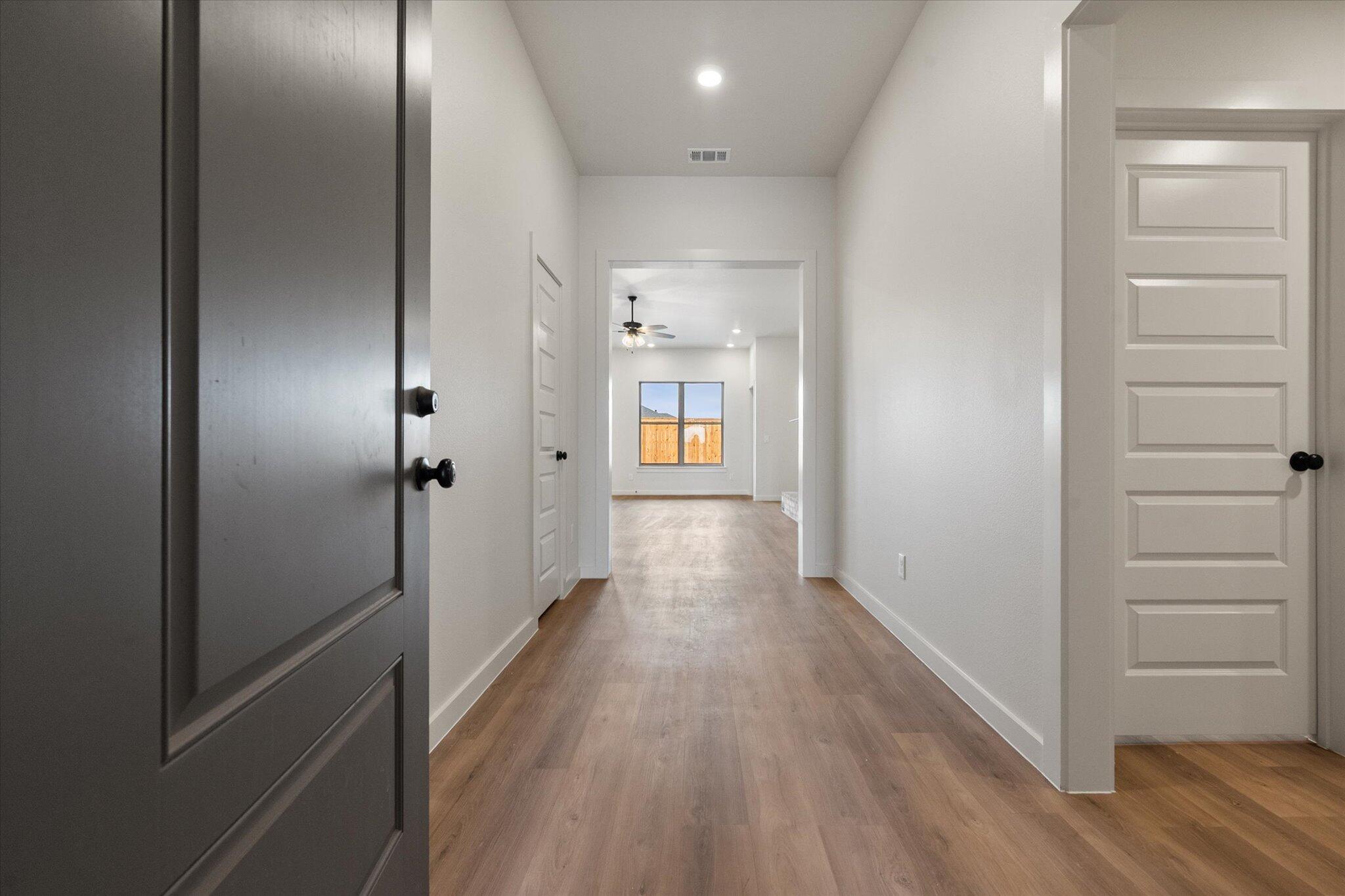 2901 Tractor Avenue Wolfforth, TX 79382 - Photo 2 of 25 a view of a hallway with wooden floor