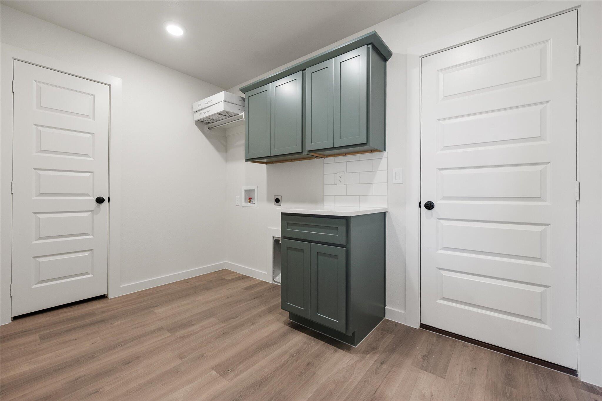 2901 Tractor Avenue Wolfforth, TX 79382 - Photo 23 of 25 a view of a kitchen with wooden floor and a sink