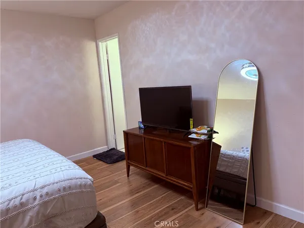 a bedroom with a bed and flat screen tv