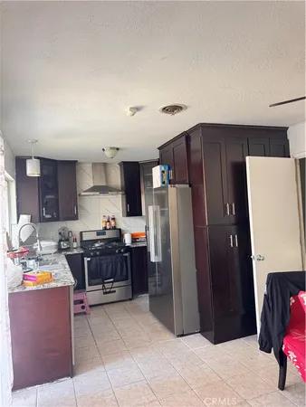 a kitchen with stainless steel appliances a refrigerator and a stove