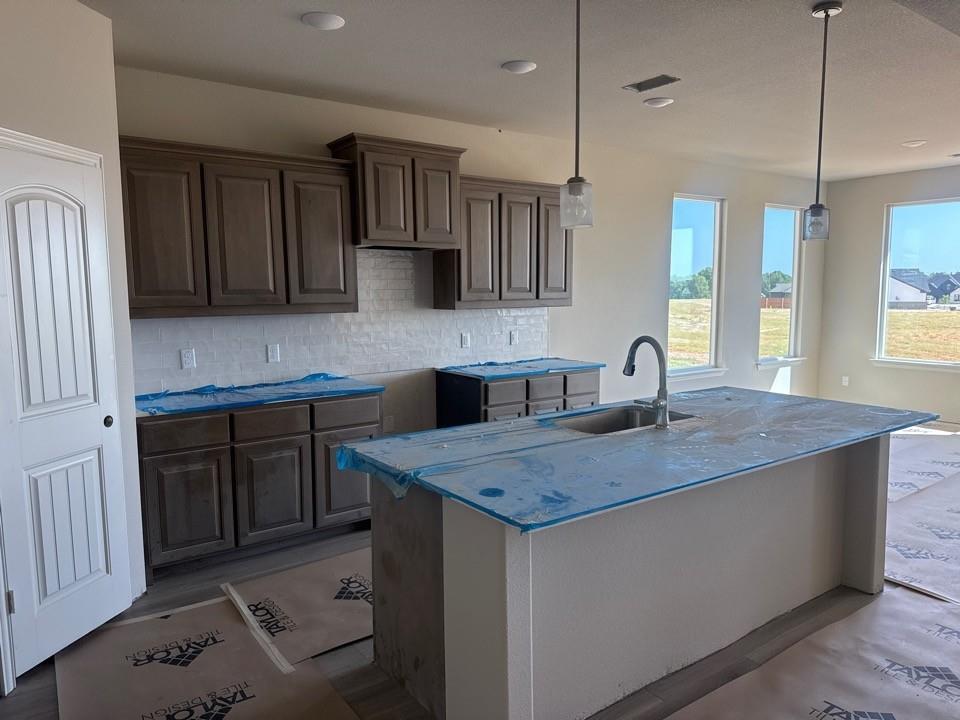 1201 Colca Drive Springtown, TX 76082 - Photo 4 of 9 a kitchen with a sink a stove a refrigerator and cabinets