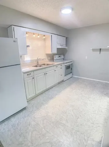 a kitchen with appliances cabinets and a sink