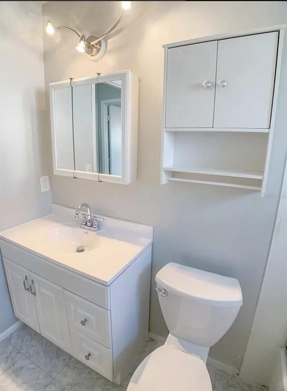 530 5th Avenue West, Unit C Palmetto, FL 34221 - Photo 14 of 27 a bathroom with a toilet sink and mirror
