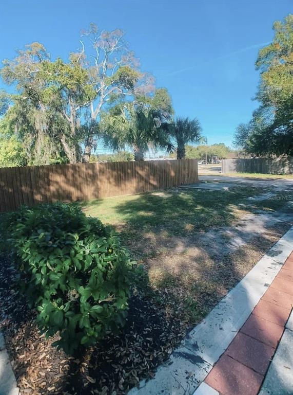 530 5th Avenue West, Unit C Palmetto, FL 34221 - Photo 26 of 27 a view of a yard with plants and large trees