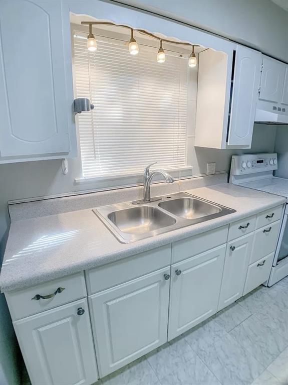 530 5th Avenue West, Unit C Palmetto, FL 34221 - Photo 10 of 27 a close view of a sink and a mirror in a kitchen