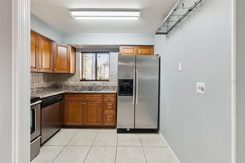 116 Springwood Circle, Unit A Longwood, FL 32750 - Photo 6 of 17 a kitchen with stainless steel appliances granite countertop a refrigerator and a sink