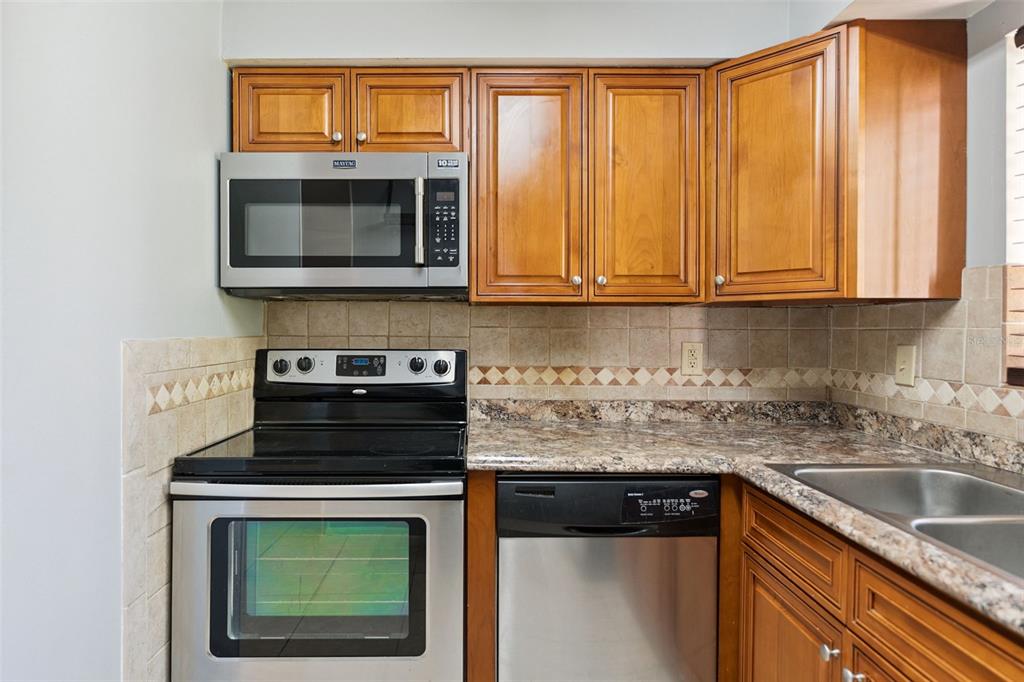 116 Springwood Circle, Unit A Longwood, FL 32750 - Photo 8 of 17 a kitchen with a stove and a microwave