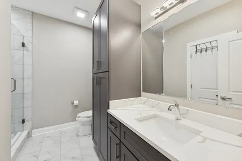 a bathroom with a sink toilet and shower