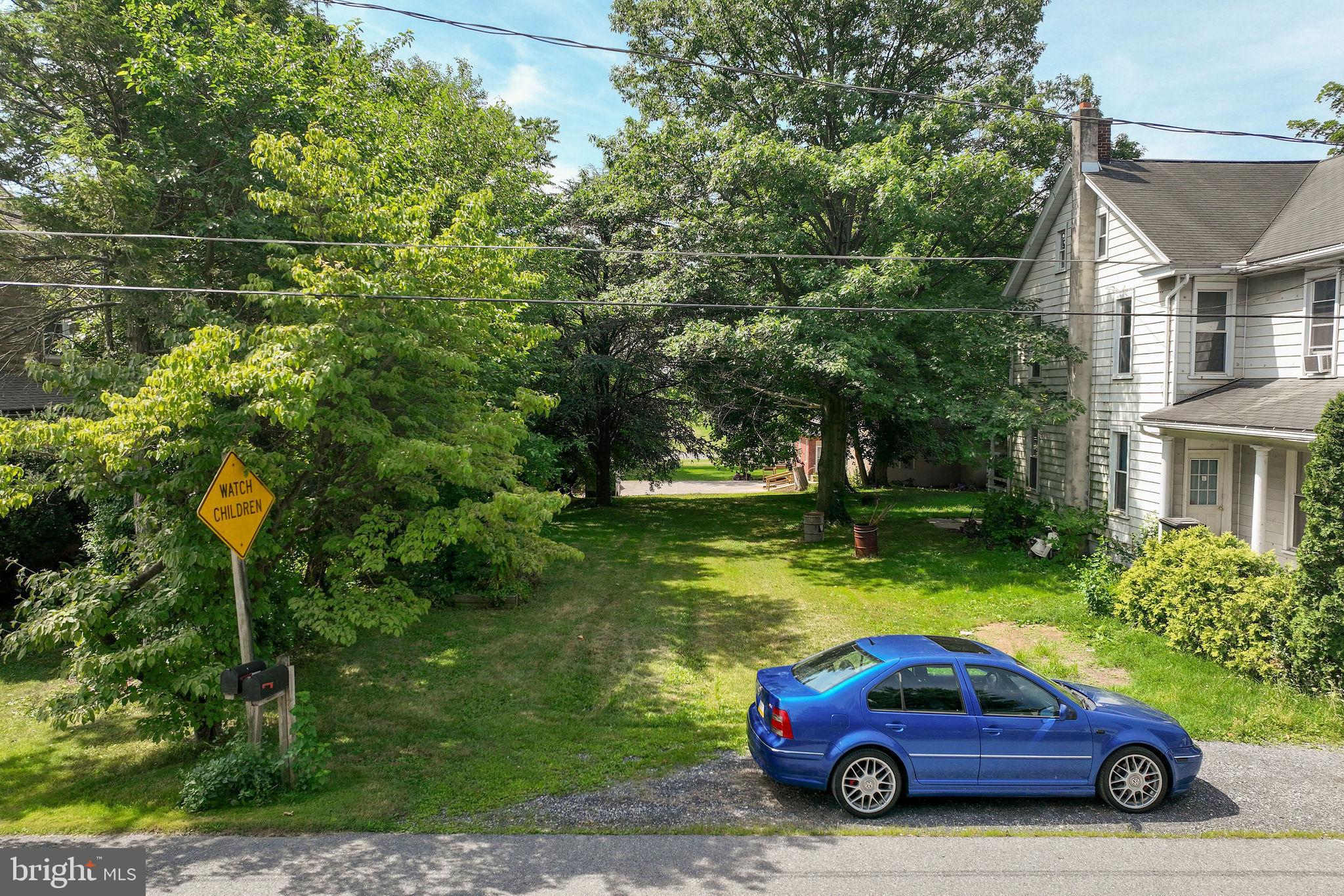 a car parked in front of a house and a yard