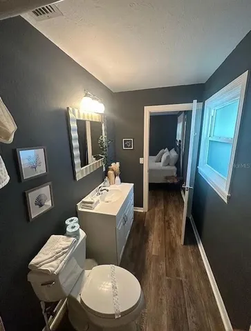 a bathroom with a toilet a sink and mirror