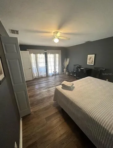 a spacious bedroom with a bed and a chandelier