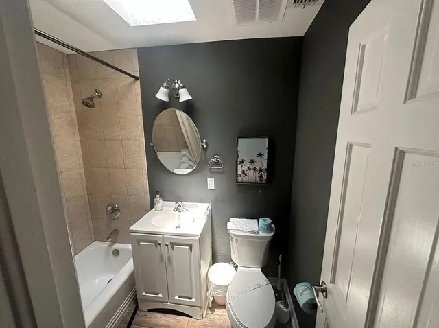 a bathroom with a toilet a sink and shower