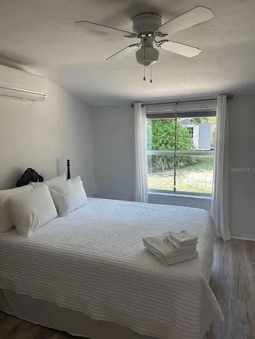 a bedroom with a large bed and a window