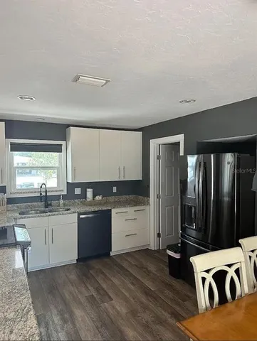 a kitchen with a sink and refrigerator