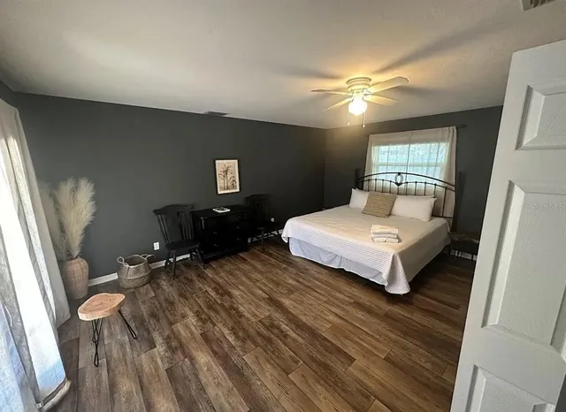 a bedroom with a bed and wooden floor