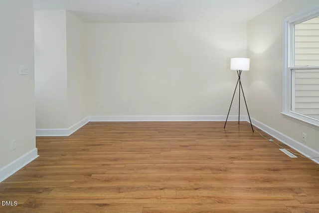 a room with wooden floor and a table