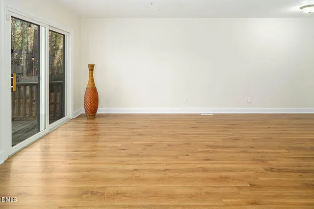 a view of a room with wooden floor