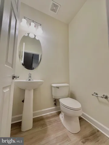 a view of an empty room with a window and fireplace