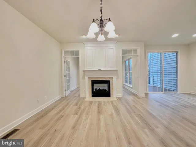 a bathroom with a granite countertop double vanity sink a mirror and a bathtub