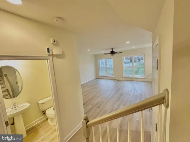 a living room with a fireplace and wooden floor