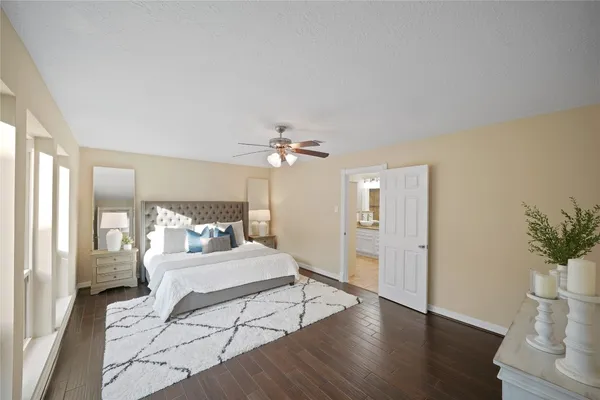 a bedroom with a large bed and a chandelier