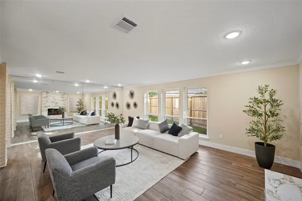 a living room with furniture and a potted plant