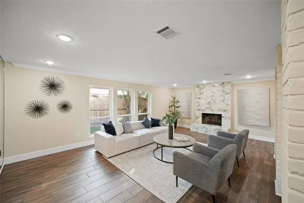a living room with fireplace furniture and a wooden floor