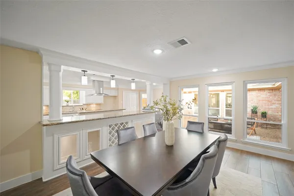 a large kitchen with lots of counter top space and dining table