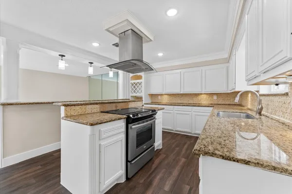 a kitchen with a stove and a sink