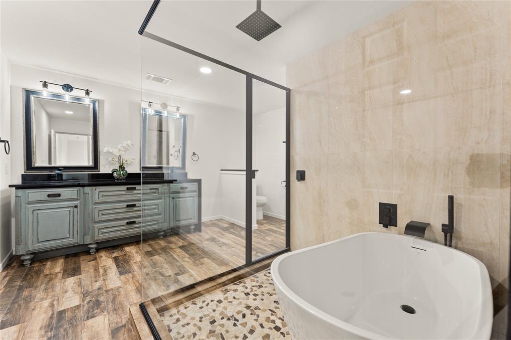 1265 North Houston Street Lorena, TX 76655 - Photo 12 of 29 a bathroom with a tub a sink and a large mirror