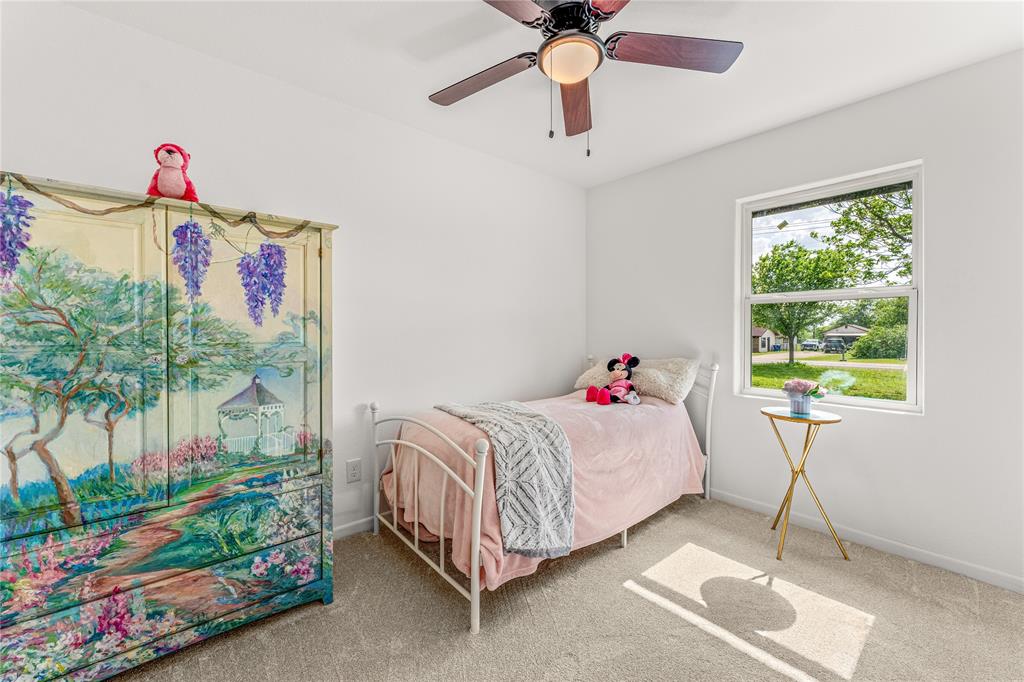 1265 North Houston Street Lorena, TX 76655 - Photo 20 of 29 a bedroom with a bed and a chandelier