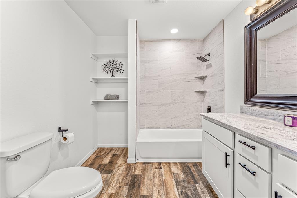 1265 North Houston Street Lorena, TX 76655 - Photo 21 of 29 a bathroom with a granite countertop sink toilet and shower