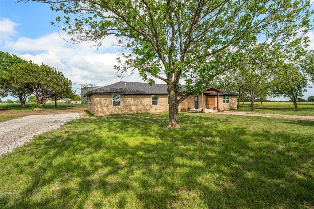 1265 North Houston Street Lorena, TX 76655 - Photo 24 of 29 a front view of a house with a yard and trees