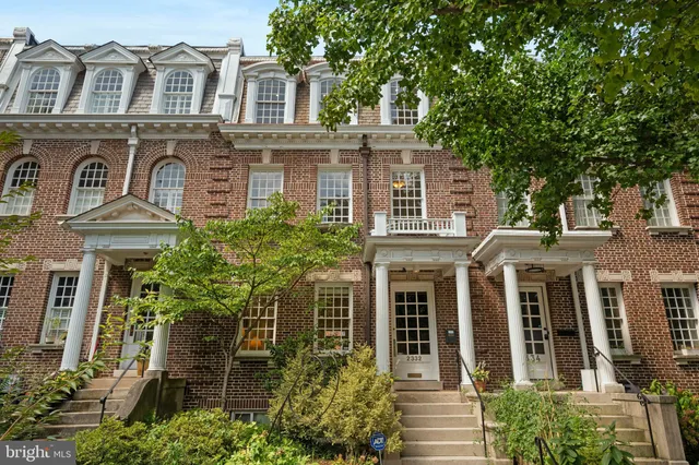 front view of a brick house with a large windows