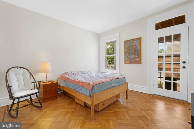 a bedroom with a bed and a lamp