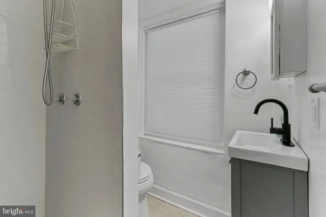 a kitchen with white cabinets and sink