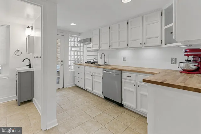a kitchen with cabinets appliances and a sink