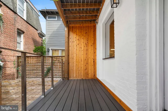 a view of a balcony with wooden floor and fence