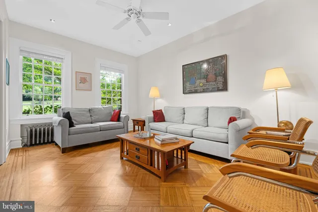 a living room with furniture and a lamp