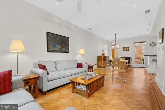 a living room with furniture and a lamp