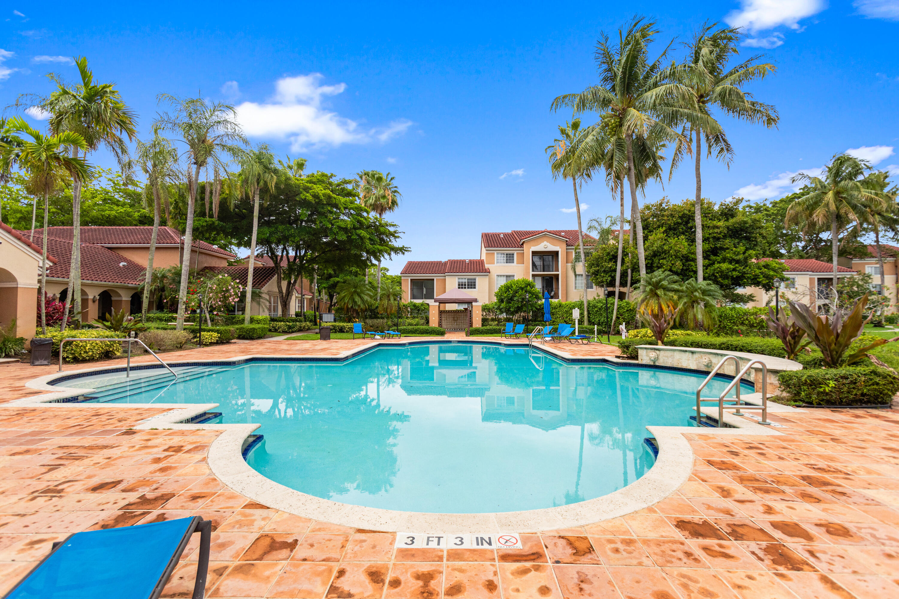 2113 Renaissance Boulevard, Unit 306 Miramar, FL 33025 - Photo 53 of 59 a view of a swimming pool with a lounge chairs