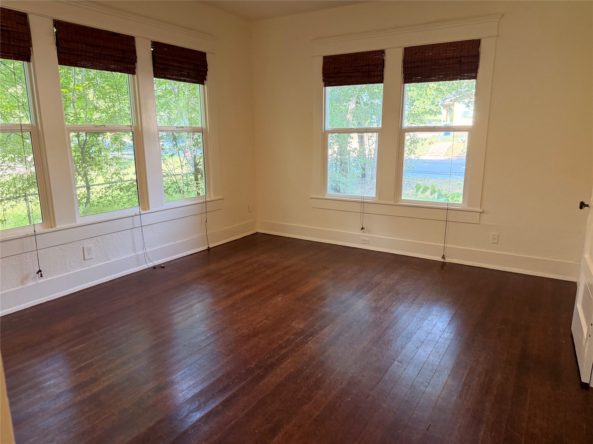 1136 Eleanor Street Austin, TX 78721 - Photo 11 of 30 Natural light floods this inviting space, highlighting the beautiful wood flooring.