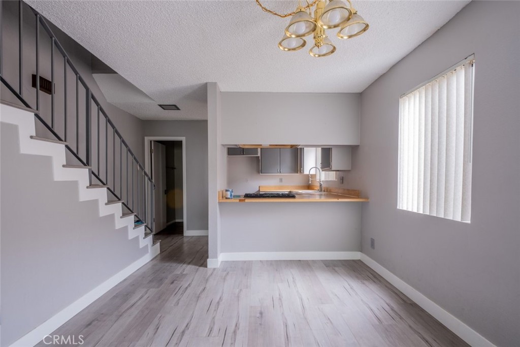 a view of kitchen with sink and wooden floor