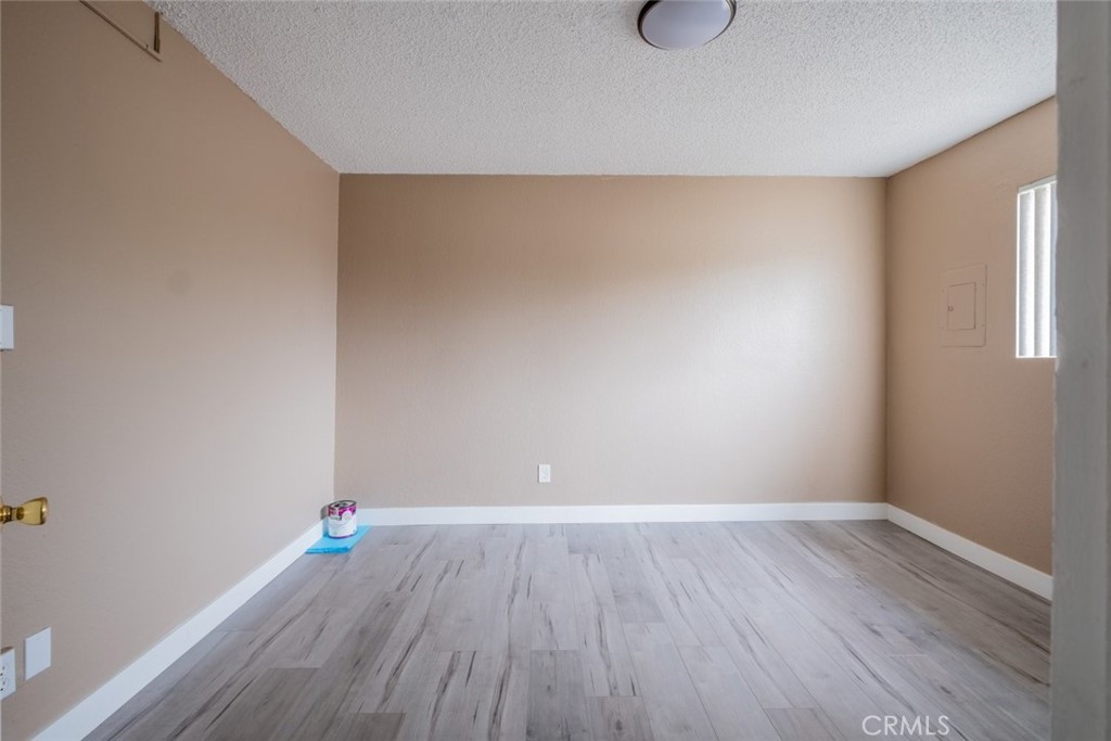 1341 North Keystone Street, Unit E Burbank, CA 91506 - Photo 14 of 16 a room with wooden floor and cabinetry