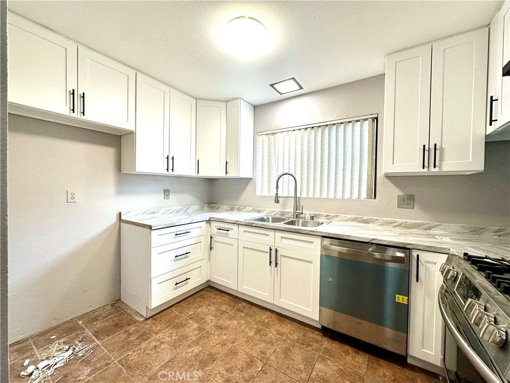 1341 North Keystone Street, Unit E Burbank, CA 91506 - Photo 4 of 16 a kitchen with a stove a sink and a window