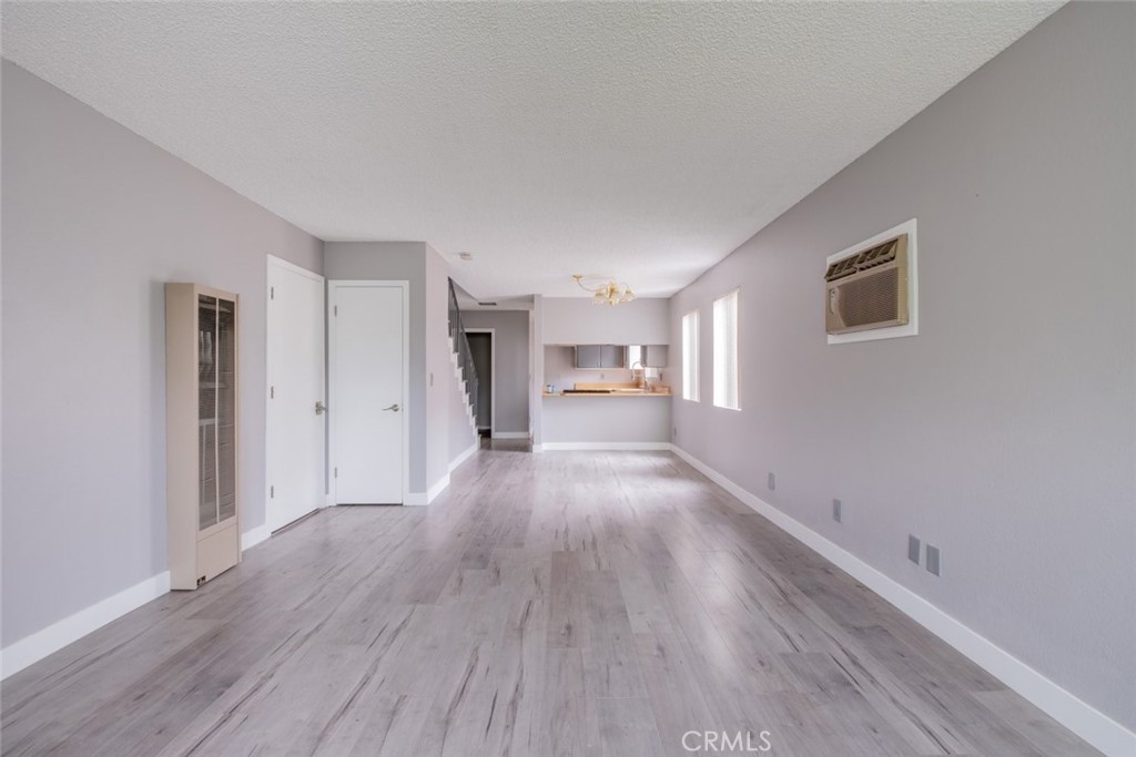 1341 North Keystone Street, Unit E Burbank, CA 91506 - Photo 5 of 16 a view of a big room with wooden floor and windows