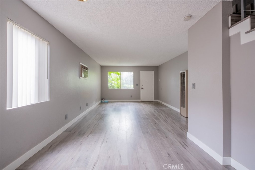 1341 North Keystone Street, Unit E Burbank, CA 91506 - Photo 6 of 16 a view of an empty room with wooden floor and window