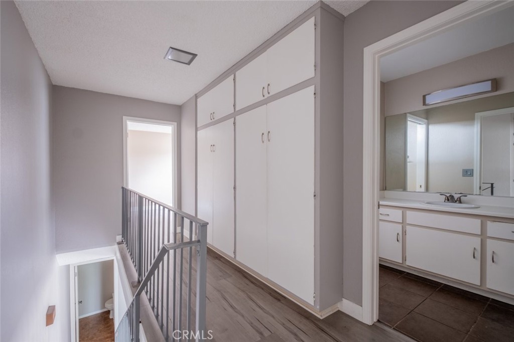 1341 North Keystone Street, Unit E Burbank, CA 91506 - Photo 9 of 16 a view of a hallway with a sink and a mirror