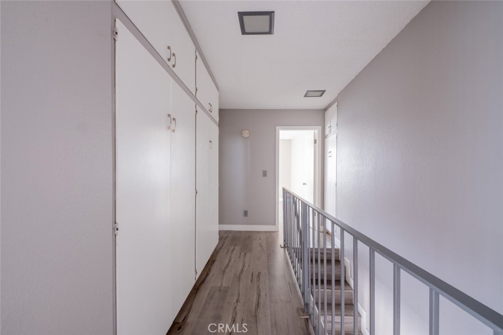 1341 North Keystone Street, Unit E Burbank, CA 91506 - Photo 10 of 16 a view of a hallway with wooden floor and staircase