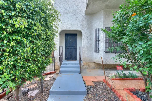 an entrance to house with yard and green space